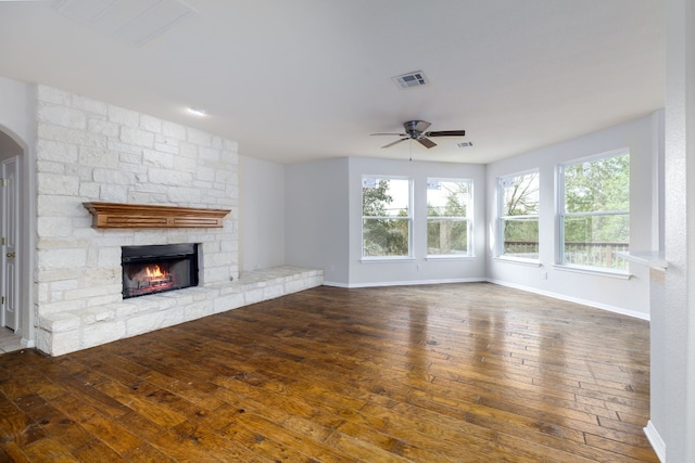 2901 Cashell Wood Dr, Cedar Park, TX 78613 - unfurnished living room featuring a ceiling fan, a stone fireplace, wood-type flooring, and baseboards