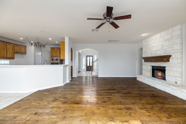 2901 Cashell Wood Dr, Cedar Park, TX 78613 - unfurnished living room with a ceiling fan, recessed lighting, arched walkways, a fireplace, and dark wood finished floors