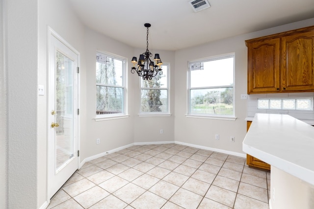 2901 Cashell Wood Dr, Cedar Park, TX 78613 - unfurnished dining area with a chandelier, healthy amount of natural light, light tile patterned flooring, and baseboards
