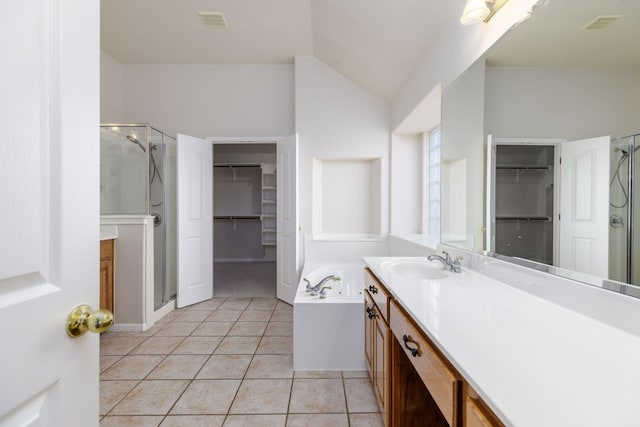 2901 Cashell Wood Dr, Cedar Park, TX 78613 - bathroom featuring a walk in closet, a stall shower, vanity, tile patterned flooring, and vaulted ceiling