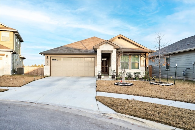 view of front of home with a garage and central AC