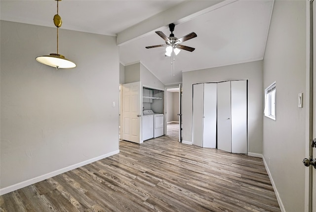 148 W Castleshoals Dr, Granite Shoals, TX 78654 - unfurnished bedroom featuring baseboards, wood finished floors, lofted ceiling with beams, and washing machine and dryer