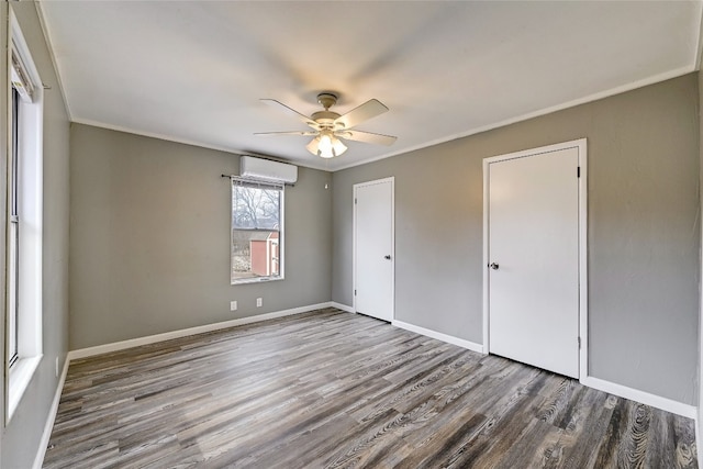 148 W Castleshoals Dr, Granite Shoals, TX 78654 - unfurnished bedroom featuring baseboards, a ceiling fan, crown molding, a wall unit AC, and wood finished floors