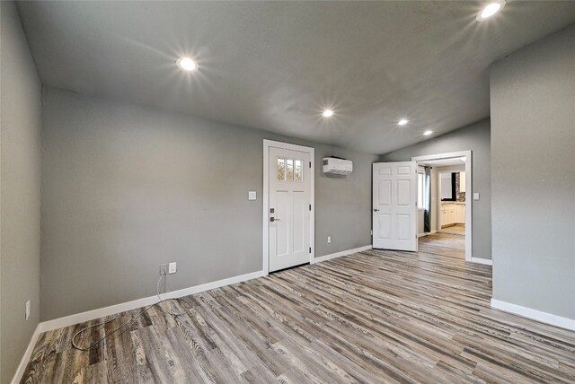 148 W Castleshoals Dr, Granite Shoals, TX 78654 - empty room featuring baseboards, recessed lighting, wood finished floors, and a wall mounted air conditioner