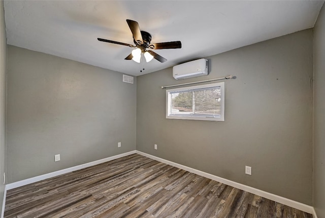 148 W Castleshoals Dr, Granite Shoals, TX 78654 - empty room with baseboards, a wall mounted air conditioner, dark wood-type flooring, visible vents, and ceiling fan