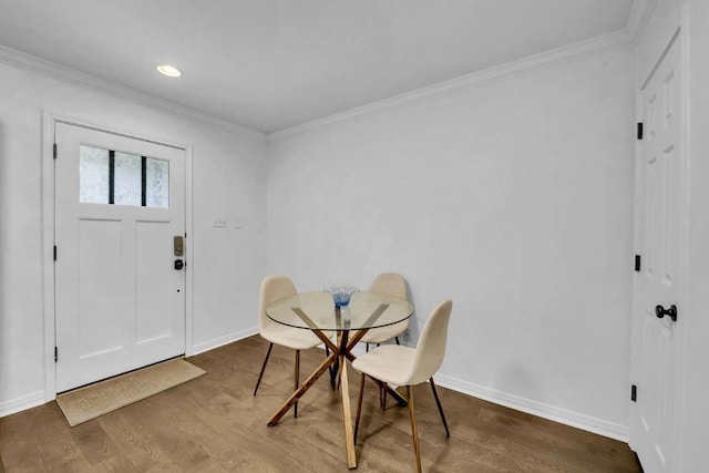 dining space featuring ornamental molding and hardwood / wood-style floors