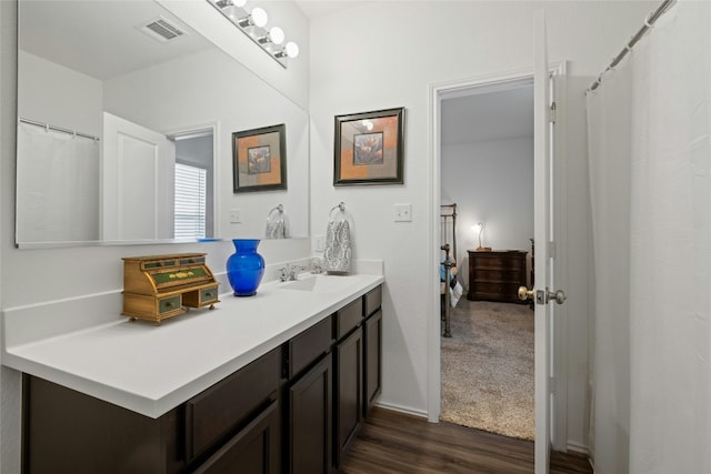 bathroom with hardwood / wood-style flooring and vanity