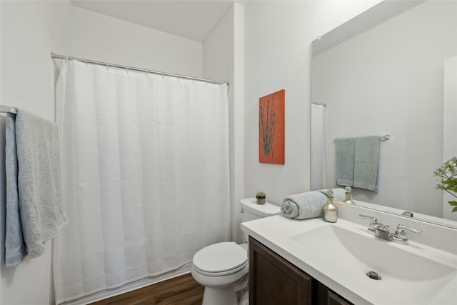 bathroom featuring vanity, hardwood / wood-style floors, and toilet