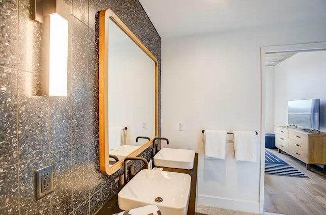 bathroom with hardwood / wood-style flooring and sink