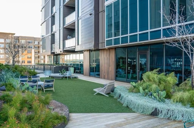 exterior space featuring a wooden deck and a lawn