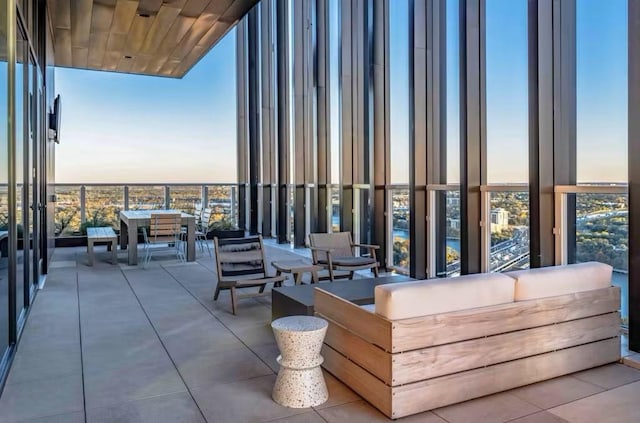 patio terrace at dusk with a balcony and an outdoor living space