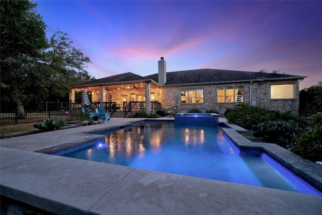 pool at dusk with a patio