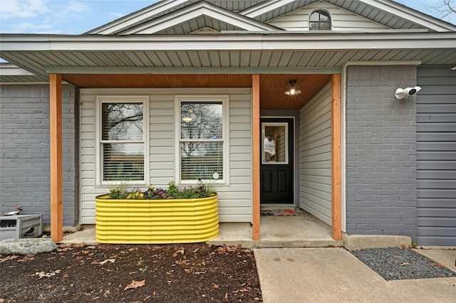 doorway to property with brick siding