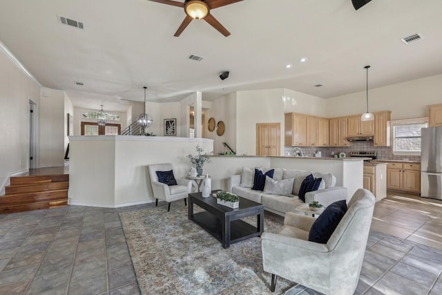 14277 Fm 2769, Leander, TX 78641 - living area with a chandelier, a ceiling fan, and light stone finish floors