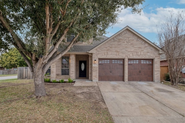 13701 Glen Mark Dr, Manor, TX 78653 - view of front facade with an attached garage, driveway, brick siding, and a shingled roof