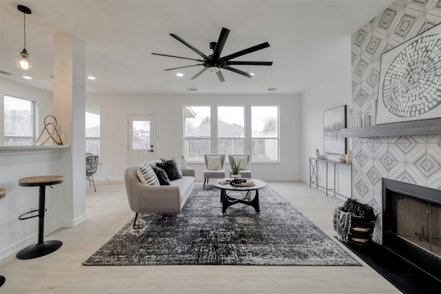 13701 Glen Mark Dr, Manor, TX 78653 - living room with a ceiling fan, a fireplace, wood finished floors, and recessed lighting