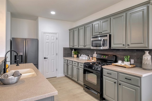 13701 Glen Mark Dr, Manor, TX 78653 - kitchen with stainless steel appliances, gray cabinetry, backsplash, and recessed lighting