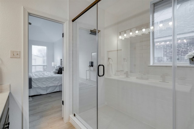 13701 Glen Mark Dr, Manor, TX 78653 - ensuite bathroom featuring a stall shower, vanity, and wood finished floors