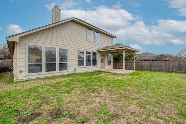 13701 Glen Mark Dr, Manor, TX 78653 - back of house with a patio area, a fenced backyard, and a chimney