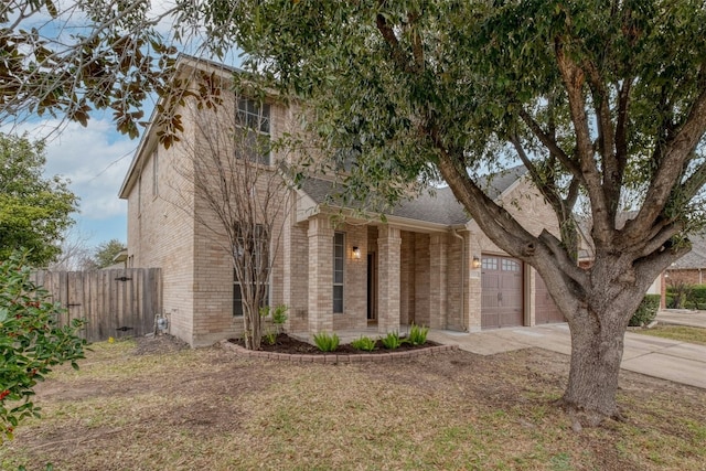 13701 Glen Mark Dr, Manor, TX 78653 - view of property hidden behind natural elements with driveway, brick siding, a garage, and a shingled roof