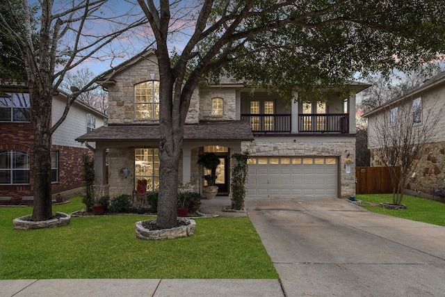 view of front facade with a garage, a lawn, and a balcony