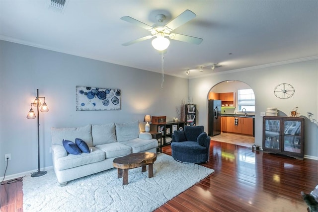 living room featuring crown molding, ceiling fan, dark hardwood / wood-style floors, and sink