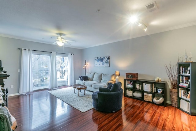 living room featuring ceiling fan, ornamental molding, and dark hardwood / wood-style flooring