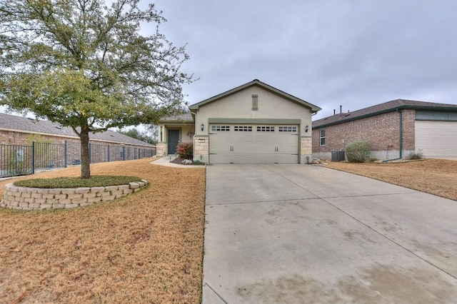 ranch-style house featuring a garage, a front yard, and central air condition unit