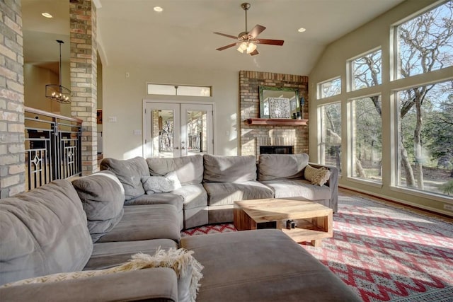 living room featuring a fireplace, high vaulted ceiling, french doors, and ceiling fan