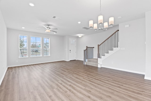 336 Blue Oasis Ln, Leander, TX 78641 - unfurnished living room featuring stairway, light wood-type flooring, a chandelier, baseboards, and recessed lighting