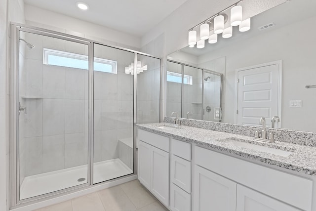 336 Blue Oasis Ln, Leander, TX 78641 - bathroom featuring a shower stall, double vanity, tile patterned flooring, and recessed lighting