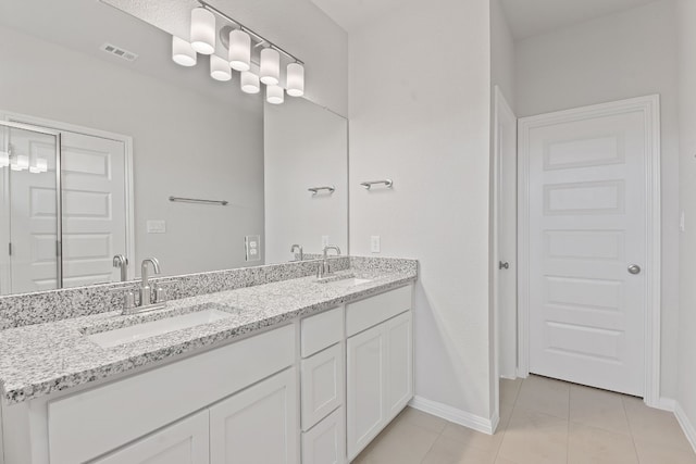 336 Blue Oasis Ln, Leander, TX 78641 - bathroom with double vanity, baseboards, and tile patterned flooring