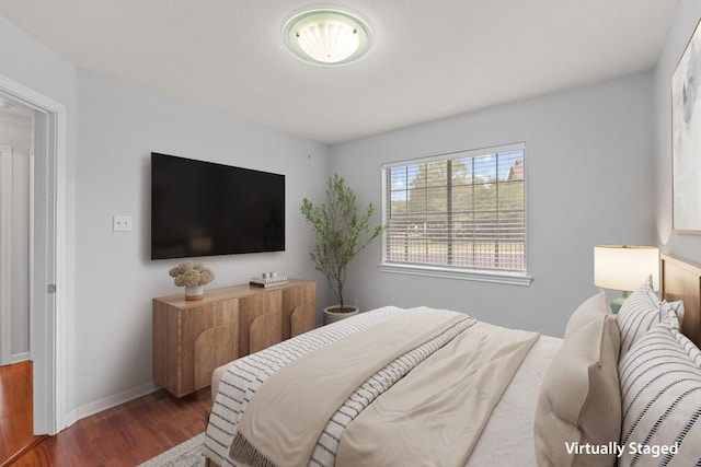 30388 Ledgemont Ln, Georgetown, TX 78628 - bedroom featuring baseboards and wood finished floors