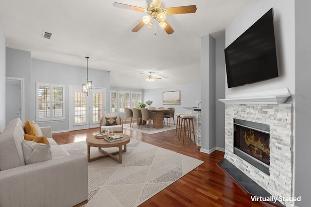 30388 Ledgemont Ln, Georgetown, TX 78628 - living area featuring a fireplace, dark wood-type flooring, visible vents, and ceiling fan