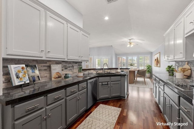 30388 Ledgemont Ln, Georgetown, TX 78628 - kitchen featuring stainless steel dishwasher, black electric cooktop, ceiling fan, a sink, and dark wood-type flooring