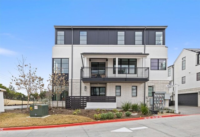 705 Ariana Ct, Austin, TX 78746 - view of front facade featuring stucco siding and a balcony