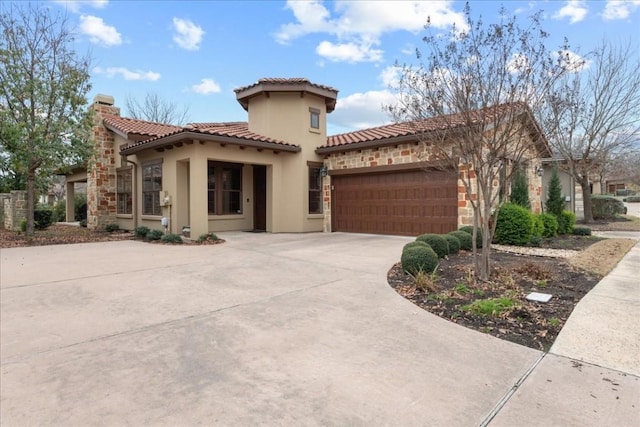 mediterranean / spanish house with an attached garage, a tile roof, driveway, stone siding, and a chimney