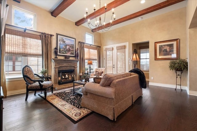 living room with dark wood-style floors, beam ceiling, french doors, and baseboards