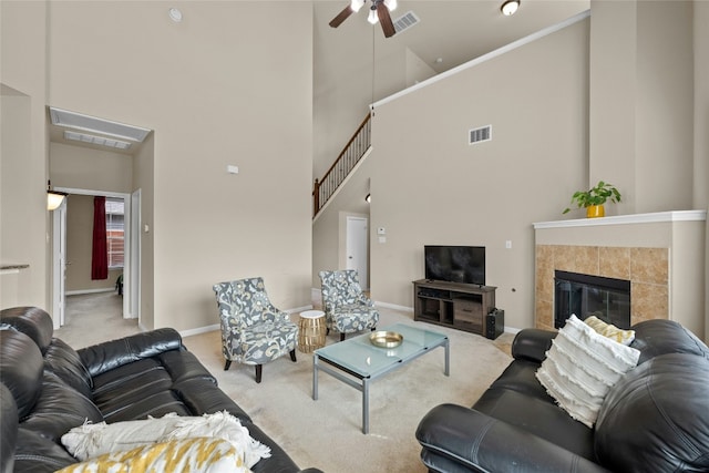 11000 Anderson Mill Rd Unit 100, Austin, TX 78750 - carpeted living room with a high ceiling, ceiling fan, baseboards, and a tile fireplace