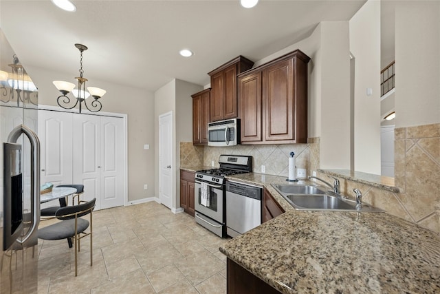 11000 Anderson Mill Rd Unit 100, Austin, TX 78750 - kitchen featuring appliances with stainless steel finishes, a sink, a chandelier, backsplash, and hanging light fixtures