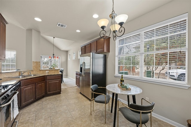 11000 Anderson Mill Rd Unit 100, Austin, TX 78750 - kitchen with appliances with stainless steel finishes, vaulted ceiling, a chandelier, a sink, and hanging light fixtures
