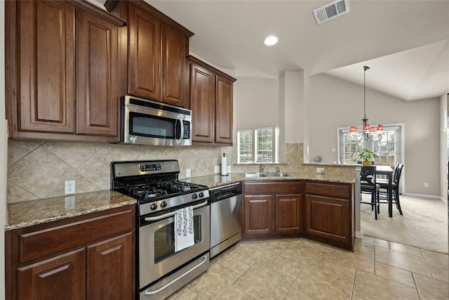 11000 Anderson Mill Rd Unit 100, Austin, TX 78750 - kitchen with stainless steel appliances, a sink, decorative backsplash, a peninsula, and recessed lighting