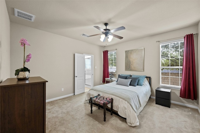 11000 Anderson Mill Rd Unit 100, Austin, TX 78750 - bedroom featuring light carpet, multiple windows, baseboards, and ceiling fan