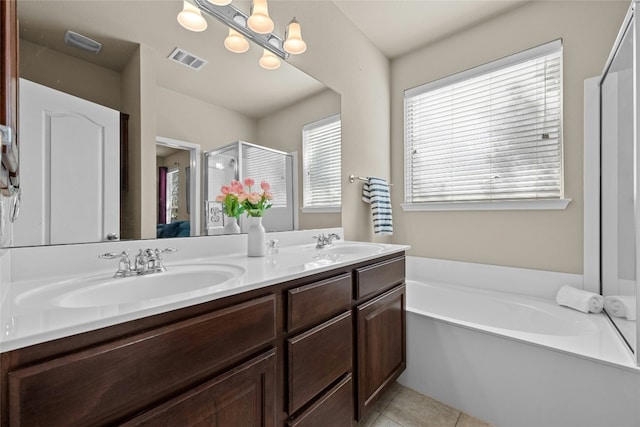 11000 Anderson Mill Rd Unit 100, Austin, TX 78750 - full bath with a stall shower, double vanity, a garden tub, and tile patterned floors