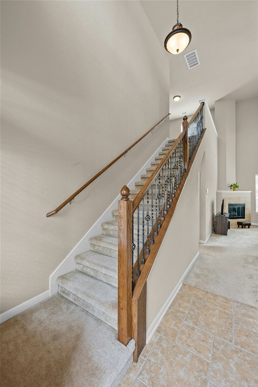 11000 Anderson Mill Rd Unit 100, Austin, TX 78750 - stairs with carpet floors, baseboards, and a glass covered fireplace