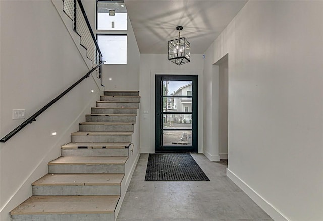 1012 Impala Dr, Granite Shoals, TX 78654 - foyer featuring stairway, baseboards, a towering ceiling, and a notable chandelier
