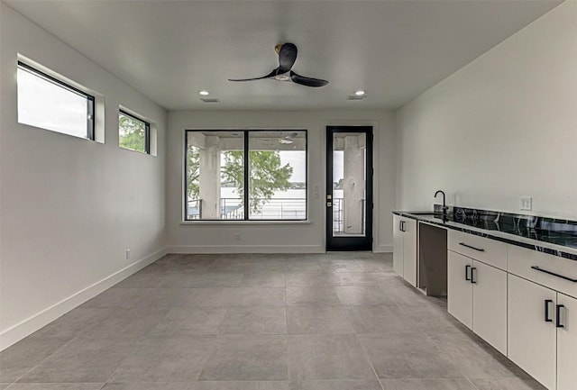1012 Impala Dr, Granite Shoals, TX 78654 - interior space with dark countertops, ceiling fan, a sink, recessed lighting, and white cabinetry
