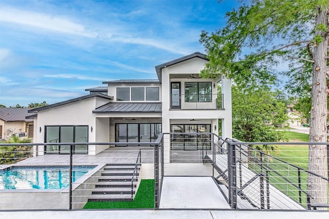 1012 Impala Dr, Granite Shoals, TX 78654 - back of property featuring stucco siding, an outdoor pool, a balcony, a standing seam roof, and metal roof