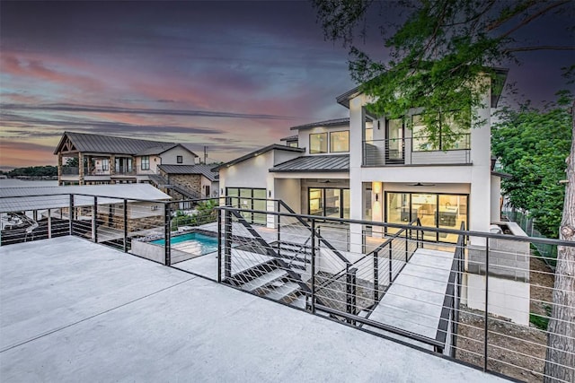 1012 Impala Dr, Granite Shoals, TX 78654 - exterior space featuring stucco siding, an outdoor pool, a balcony, a patio, and metal roof