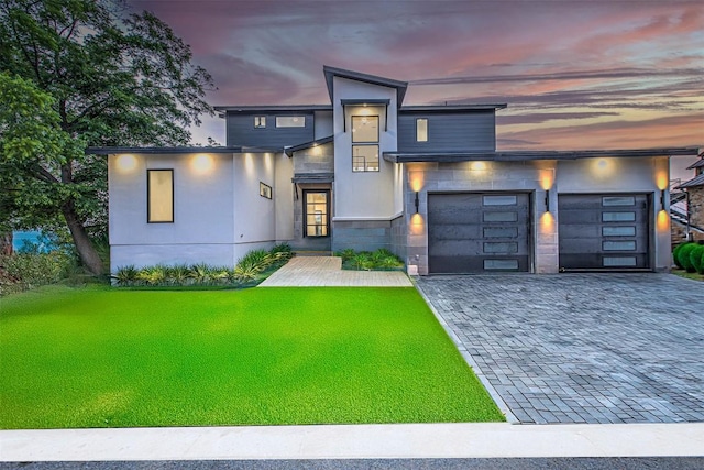 1012 Impala Dr, Granite Shoals, TX 78654 - contemporary house with a garage, decorative driveway, a lawn, and stucco siding